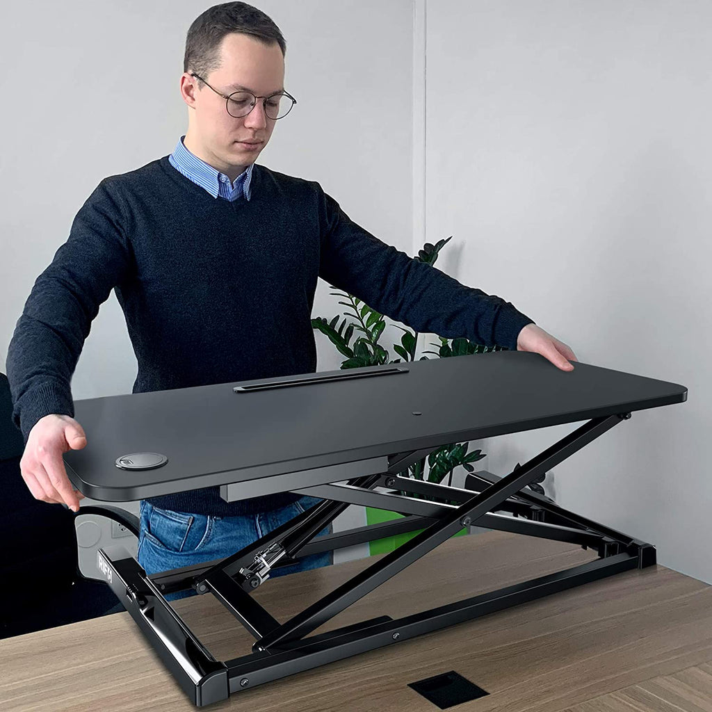 Height Adjustable Standing Desk 37 inch with concealed handles man demonstrating how to use the desk
